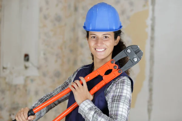 happy woman builder with tools in hand