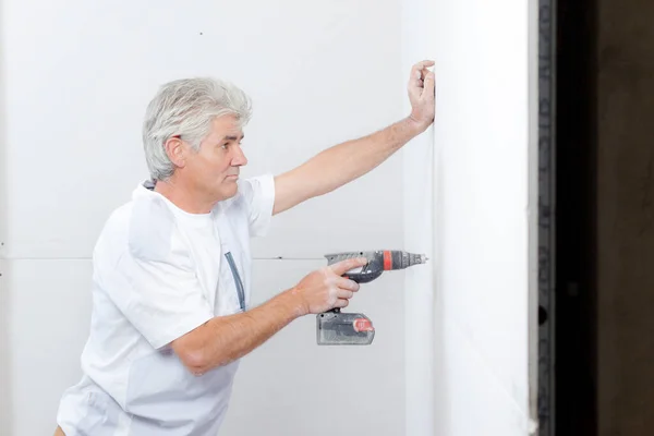 Male Worker Drilling Dry Wall — 图库照片