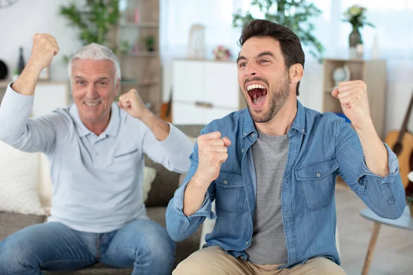 Father Son Sitting Together Watching Football Match —  Fotos de Stock
