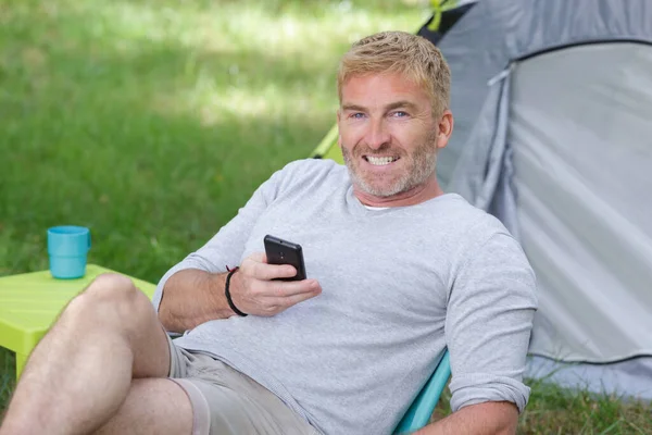 Man Using Phone While Camping —  Fotos de Stock