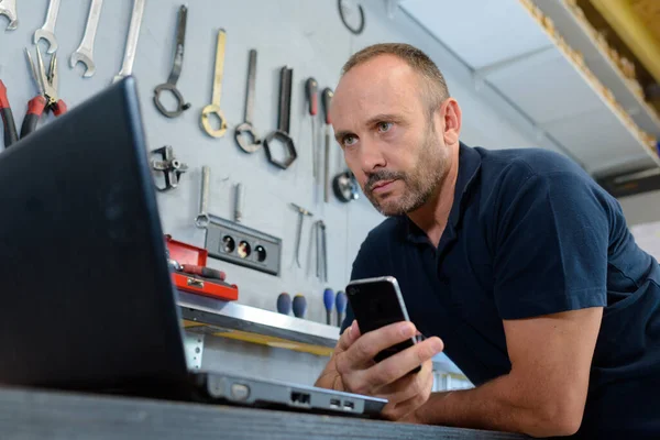 picture of a man in the workshop looking at computer