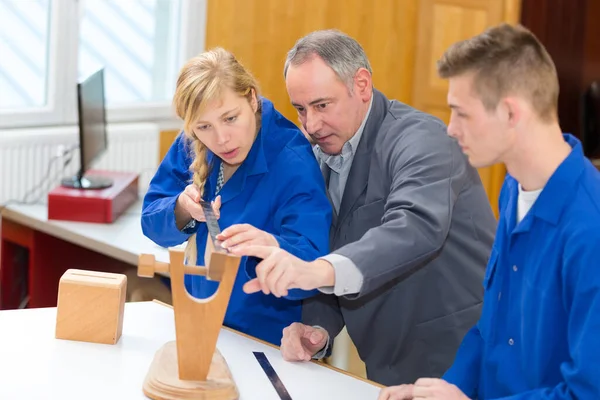 Carpenter Teaching Female Apprentice How Measure Wood — Stockfoto