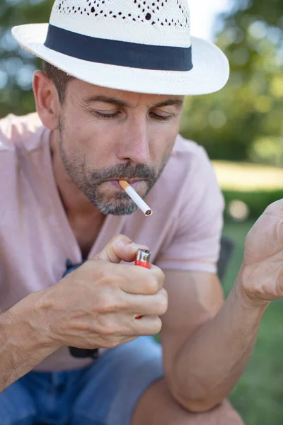 Young Man Sits Park Bench Cigarette — Stockfoto