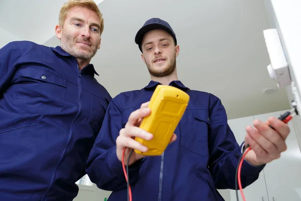 Young Male Electricians Installing Electrical Socket — Photo