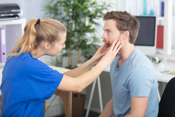 Woman Doctor Checking Male Patients Throat — Stok fotoğraf