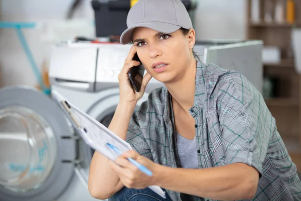 专业的妇女修理工修理洗衣机 — 图库照片