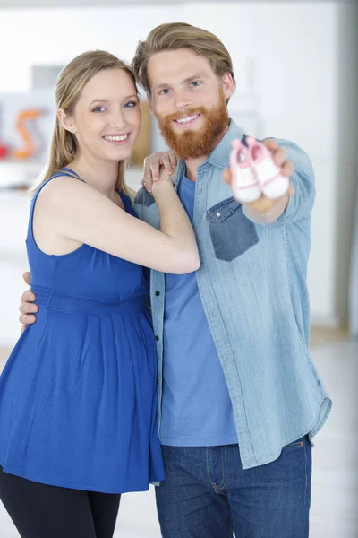 Happy Oouple Showing Baby Shoes — Stock Photo, Image