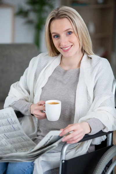 Kvinna Hemma Rullstol Håller Tidning Och Kaffe — Stockfoto