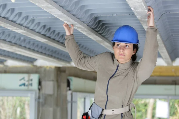 female contractor examining concrete roof construction