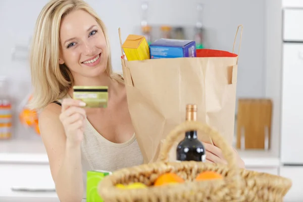 smiling young woman at home after shopping