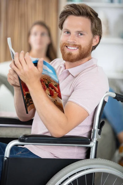 handicapped man holding a travel brochure