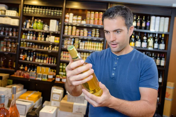 Handsome Young Man Choosing Fine Wines — Stock Photo, Image