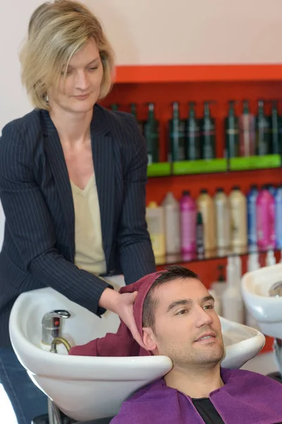 Pleasant Professional Hairdresser Washing Hair Client — Stock Photo, Image