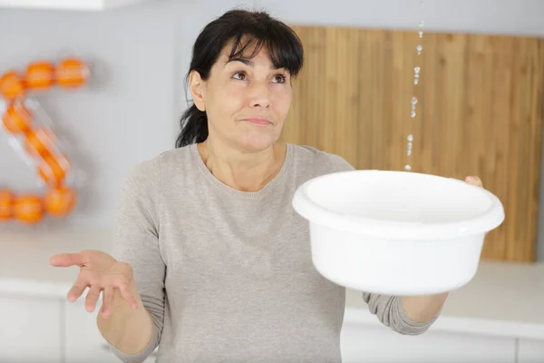 Mulher Segurando Balde Enquanto Gotas Água Vazam Teto — Fotografia de Stock