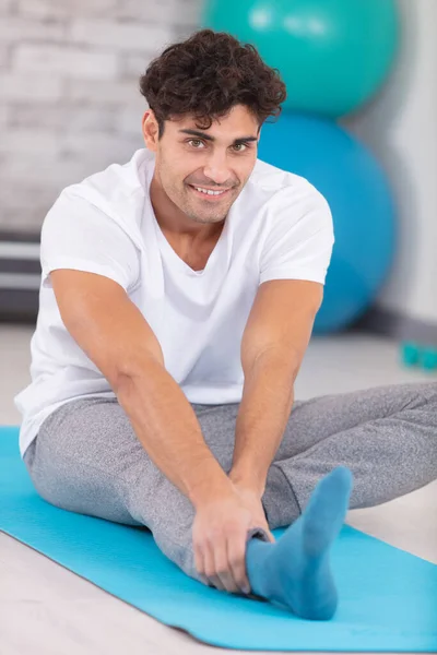 Man Doing Hamstring Stretch Exercise Top Mat Royalty Free Stock Images