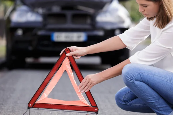 Woman Putting Safety Red Triangle — Stock Photo, Image