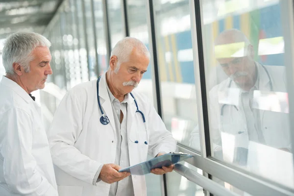 doctors studying the information on the clipboard