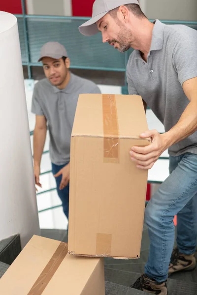Deliverymen Happy Faces Carry Cardboard Boxes — Stock Photo, Image
