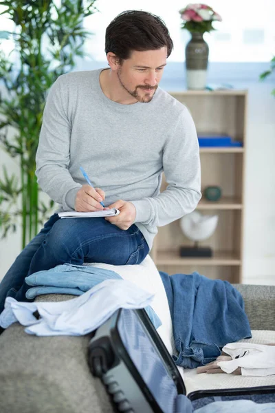 Young Man Packing Suitcase Summer Journey Bed — Stock Photo, Image