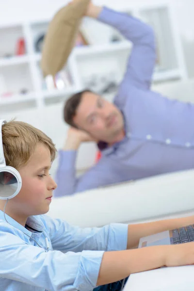 Man Poised Throw Cushion Young Boy Computer — Stock Photo, Image