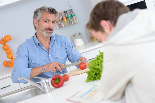 Man Chopping Vegetables Talking Teenager — Stock Photo, Image