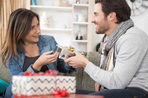 man giving gift to his girlfriend