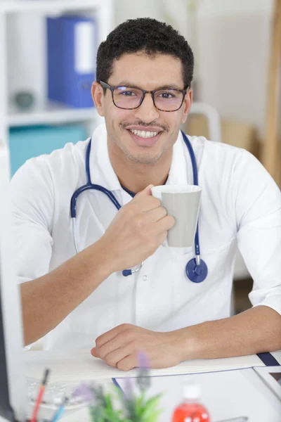 doctor with coffee cup in medical office