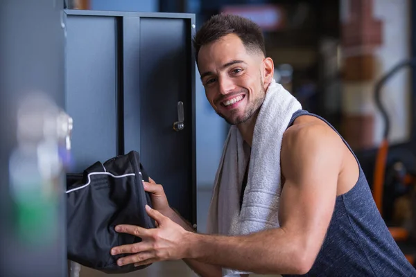 happy male bodybuilder in the locker room