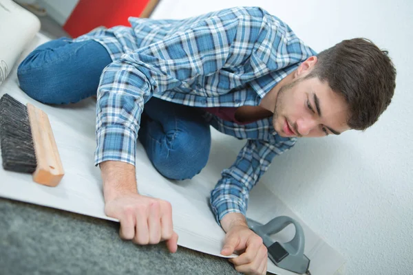 Young Male Fitting Carpet — Stock Photo, Image