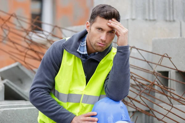 a sad worried engineer outdoors