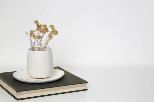 乾燥したセラミックマグカップテーブルの上の本に永遠の花 シンプルな家の装飾 — ストック写真