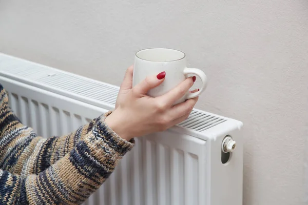 Woman Warming Hands Tea Cup Heating Radiator — Stock Photo, Image