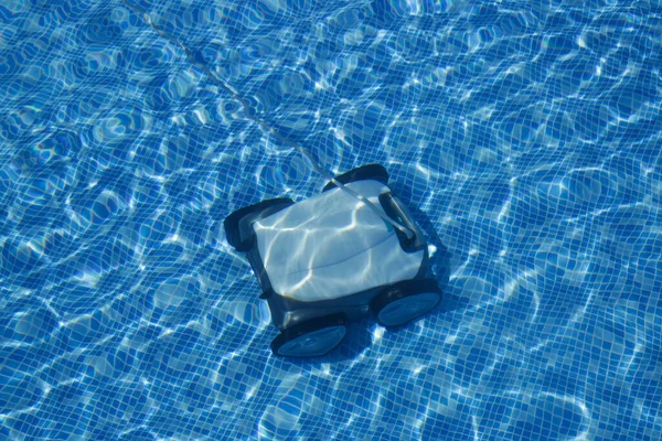 Cleaning the pool floor with an underwater vacuum cleaner, pool maintenance concept.