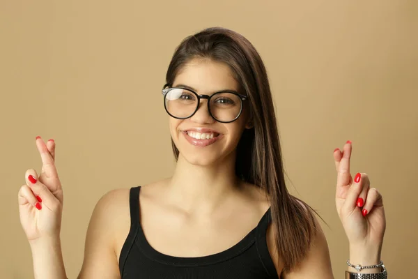 Studio Portrait Smiling Pretty Woman Showing Crossed Fingers Gesture Making — Zdjęcie stockowe