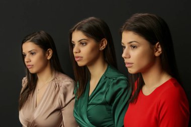 Three beautiful Caucasian women, side view, studio shot