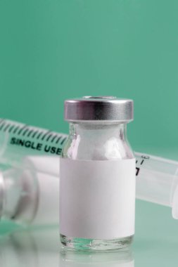 Vaccine bottle with blank white label.Vaccination, immunization, treatment to provides active acquired immunity to a particular infectious disease. Healthcare And Medical concept.