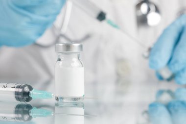 Scientist or medical worker holds vaccine bottle.Vaccination, immunization, treatment to provides active acquired immunity to a particular infectious disease. Healthcare And Medical concept.
