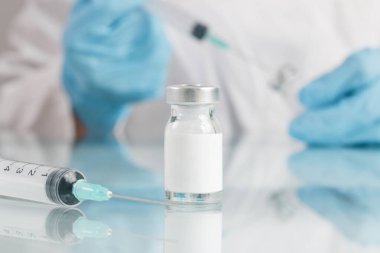 Scientist or medical worker holds vaccine bottle.Vaccination, immunization, treatment to provides active acquired immunity to a particular infectious disease. Healthcare And Medical concept.