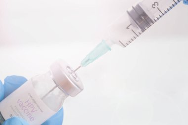 Scientist or medical worker holds HPV vaccine bottle.Vaccination, immunization, treatment to provides active acquired immunity to a particular infectious disease. Healthcare And Medical concept.