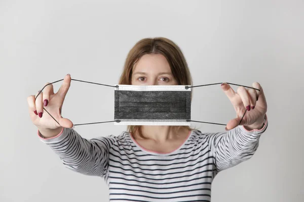 Young Woman Takes Protective Mask Looking Camera Studio Shot Removing — Stock Photo, Image