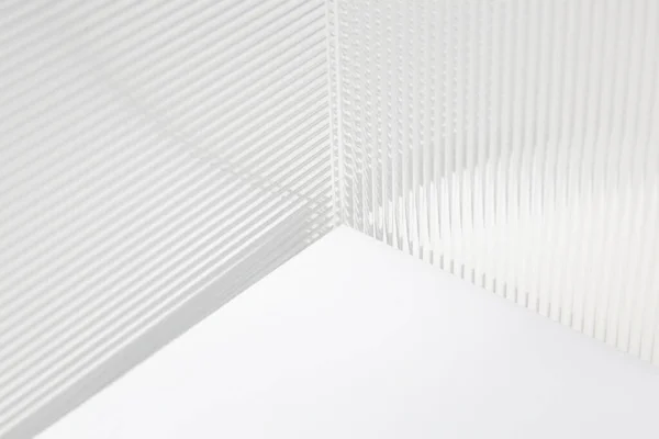 Stripe texture acrylic sheet. Clear linear prismatic panel, extruded linear ribs acrylic sheet. Abstract minimal graphic design resource.Close up of clear transparent plexiglass.