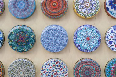 Display of decorative colorful souvenirs, magnets, tiles or boxes.