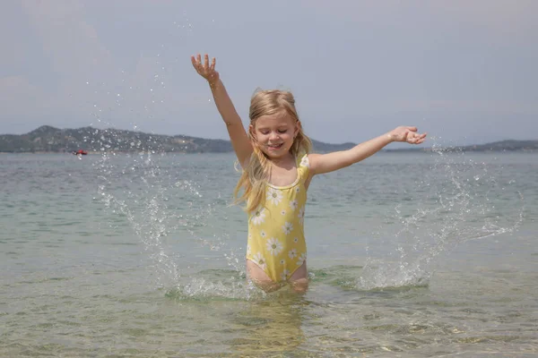 Adorable Toddler Girl Yellow Swimsuit Splashing Water Beach Idyllic Summer — Foto Stock