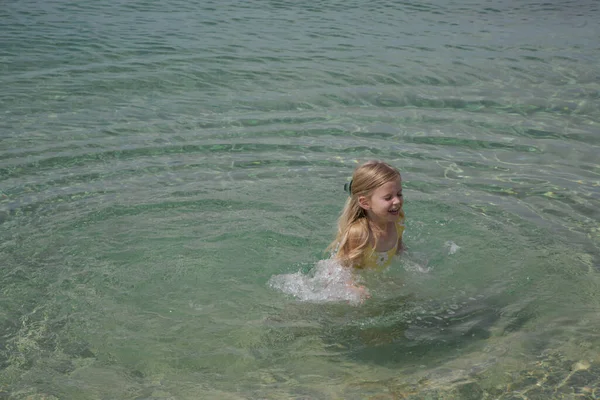 Entzückendes Kleinkind Gelbem Badeanzug Das Strand Mit Wasser Planscht Idyllisches — Stockfoto