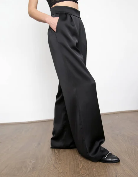 Studio Shot Female Model Wearing Black Satin Wide Trousers — стоковое фото