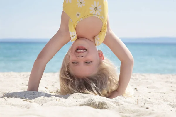 Happy Little Girl Standing Upside Sandy Beach Healthy Lifestyles Concept — стоковое фото