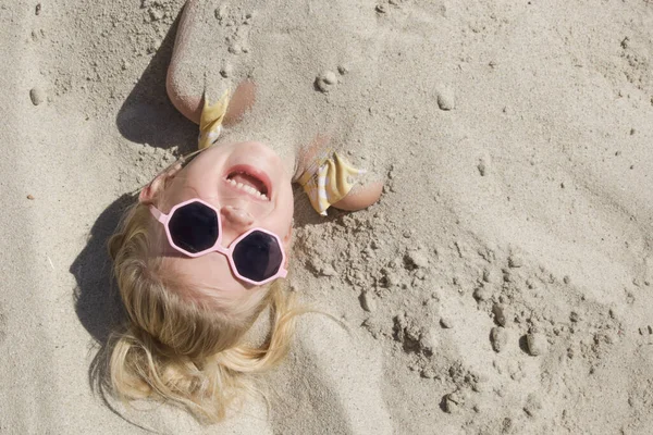 Cute Happy Little Girl Buried Sand Beach — Stockfoto