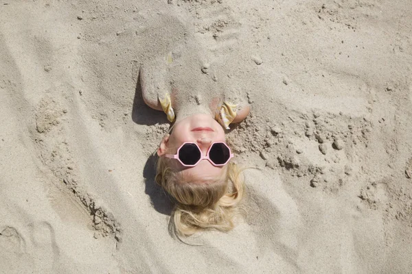 Cute Happy Little Girl Buried Sand Beach — ストック写真