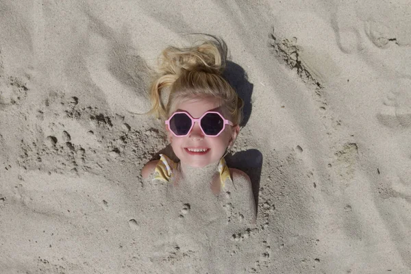 Cute Happy Little Girl Buried Sand Beach — Photo