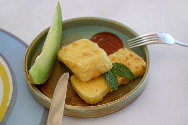 Matured cheese served with melon slice